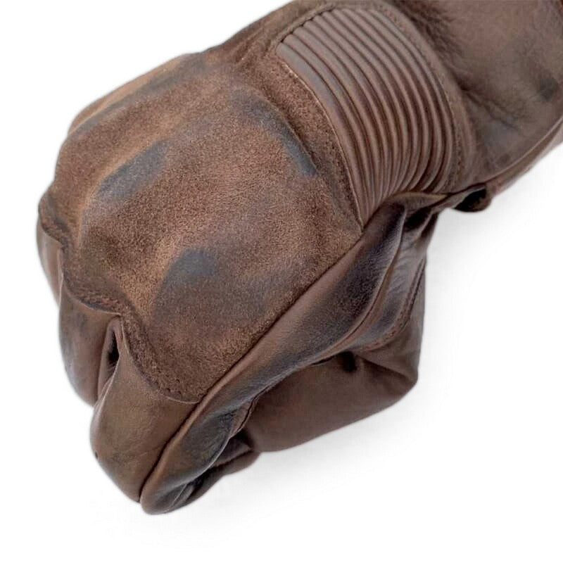 
With its vintage ace, the stylish Crosby glove has the protection to match – CE Certified to Level 1 KP. Made from premium Aniline Waxed leather, the glove comes with motion panels, pre-curved fingers, and an elastic cuff for added comfort. 
ARMOUR  CE Certification Rating: Level 1 KP TPU knuckle  
CONSTRUCTION  Outer: Premium aniline waxed leather Polyester lining with foam  
FEATURES & BENEFITS  Embossed logos Double layer leather at palm Pre-curved fingers Hook and loop wrist closure Per